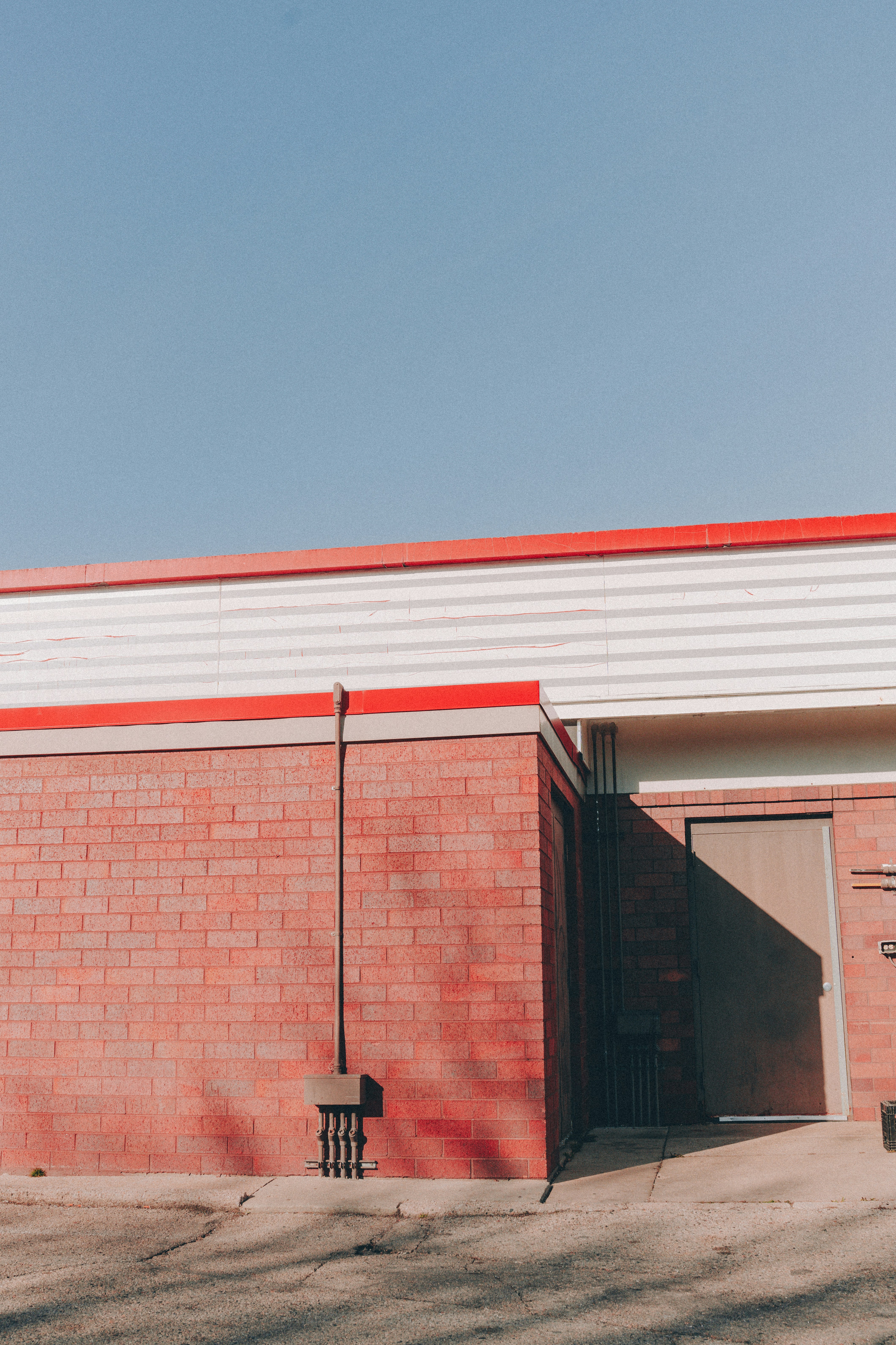red gas station minimal blue sky